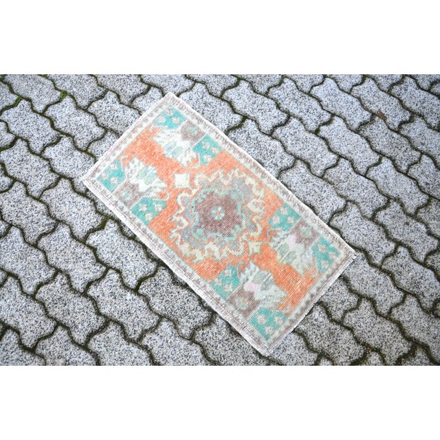 This is a vintage Turkish Oushak rug from the 1960s. The piece was hand-knotted.