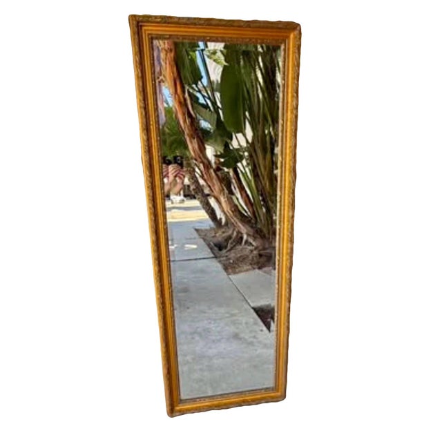 Ornate gilt vintage carved wood full length mirror. Exceptional clarity in the glass for its age and in incredible vintage...