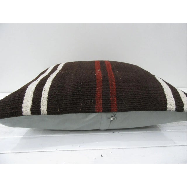 This is a pillow cover made from a vintage kilim rug. The piece was properly washed and ready to use. Pillow inserts not...