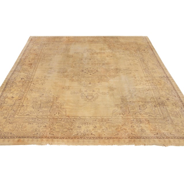 An 11x12 vintage rug celebrating the Oushak style, hand knotted in wool originating from Turkey circa 1950–1960. The...