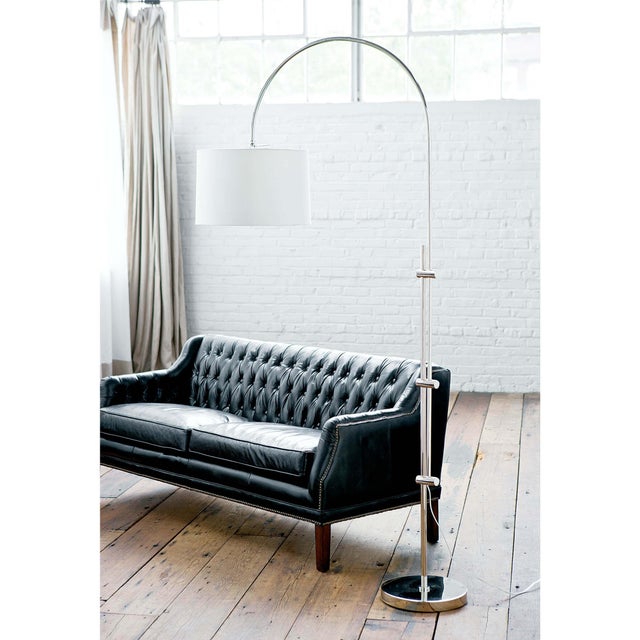 The juxtaposition of a metallic, adjustable base with a fabric shade gives this floor lamp a modern aesthetic—seamlessly...