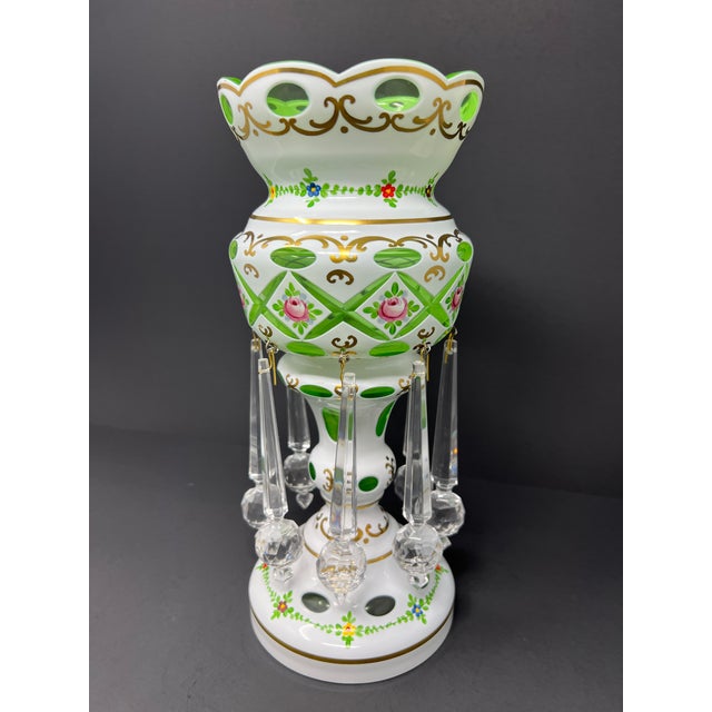 A striking vintage Bohemian art glass luster vase featuring hand-painted enamel roses, gilt scrollwork, and faceted...