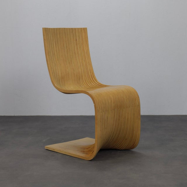 A striking pair of contour chairs designed by alejandro estrada for piegatto in 2006. Crafted from laminated bamboo, the...