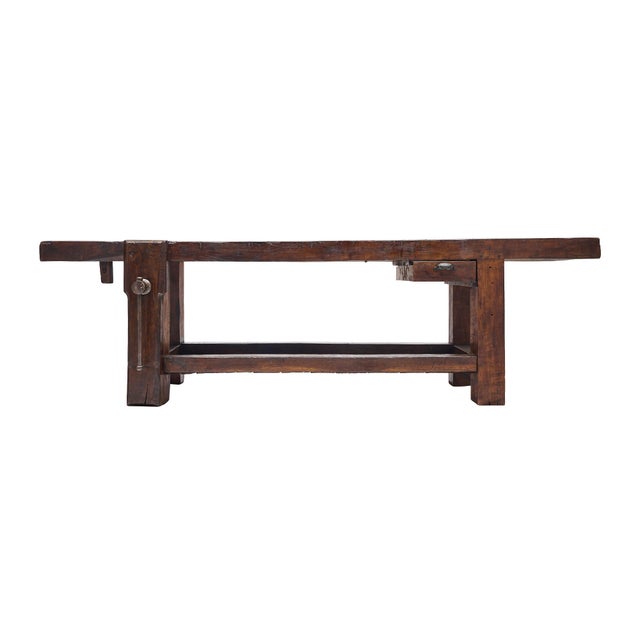 Workbench from the French Alps made of waxed and patinated chestnut wood. The bench features the original vise and clamp...