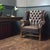 A high-quality English vintage wingback armchair in brown leather, executed in the George III style. The backrest,...