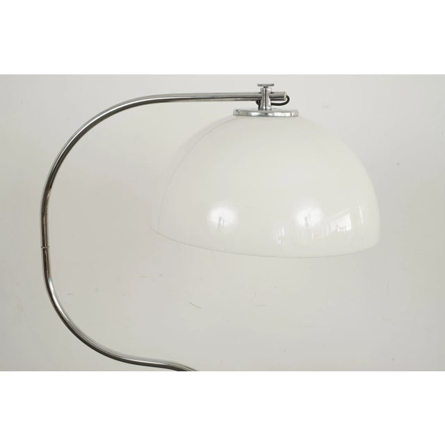 Arced chrome floor light. The light has an arced chrome frame with a white plastic shade. It comes with a chrome metal...