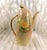 This is a tan hand painted and signed chocolate pot, teapot or coffee pot. The pot is a tan color with yellow roses and...