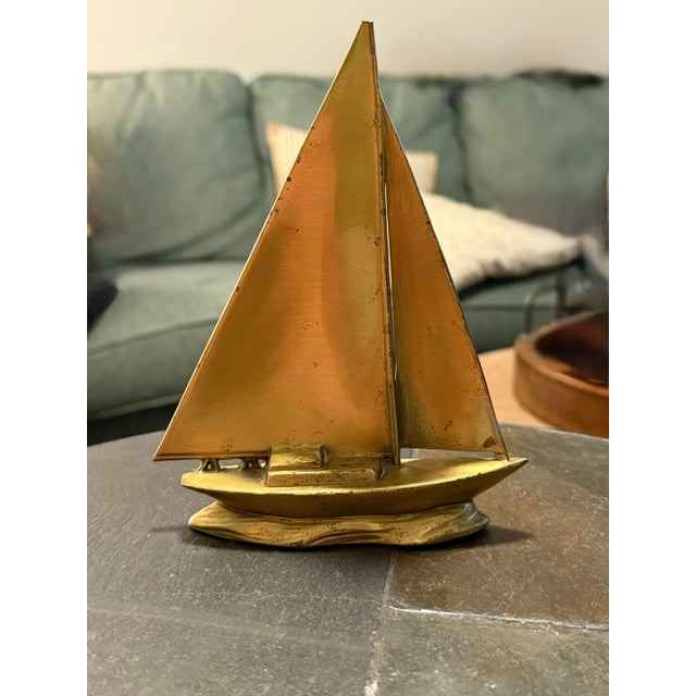 Beautiful vintage solid brass sailboat sculpture featuring elegant twin sails and a detailed wave-inspired base. Measuring...