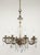1930s Victorian style eight arm chandelier made of faceted teardrop crystals and an etched central crystal stem with an...