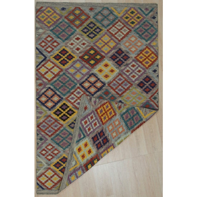 Nadia Kilim Multicolor Flatweave Wool Rug, Country of Origin: India. This exceptional flatweave piece showcases the...