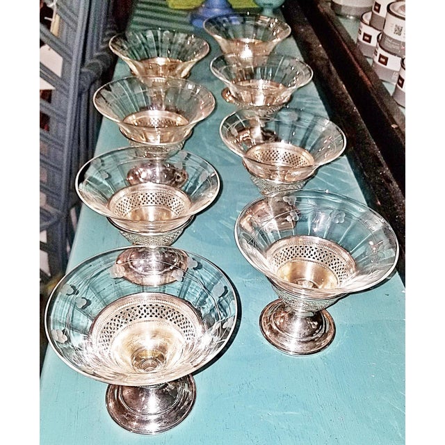 Imagine serving your next champagne in this set of 8 sterling silver and etched crystal coupes by Elgin Silversmiths of...