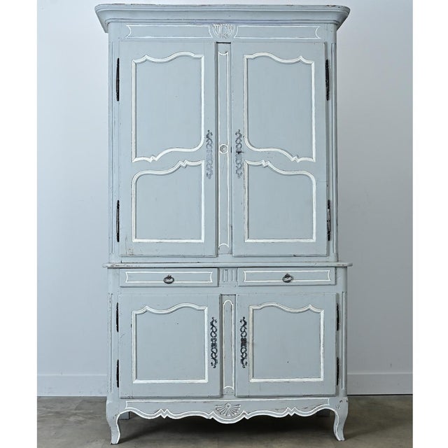 This 19th-century French buffet a deux corps is elegant in design and made playful by its more recent powder blue paint...