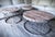 This striking three-piece set includes one round coffee table and two matching side tables, each topped with solid...