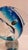 This listing features a Murano glass dolphin sitting on top of a clear glass sphere. While the sculpture is mostly...