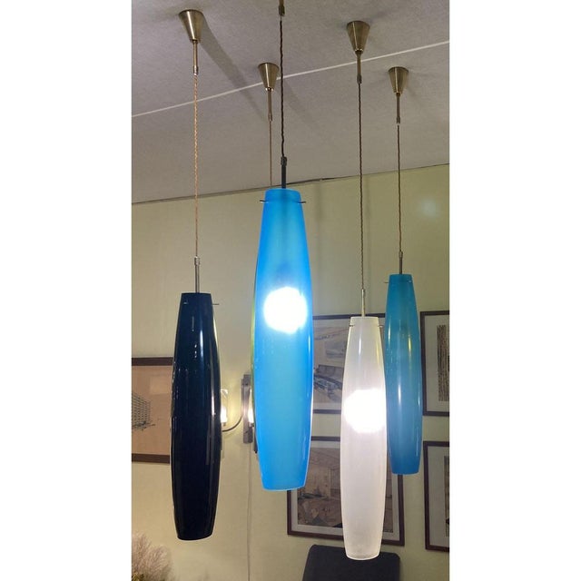Large elongated Murano blown glass pendants in blue, (Inside is a blown thin inner layer of white opal translucent glass...
