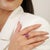 Featuring an 11 mm round-cut ruby gemstone weighing 6.1 carats, accented with diamonds weighing 0.1 carat, this 925...