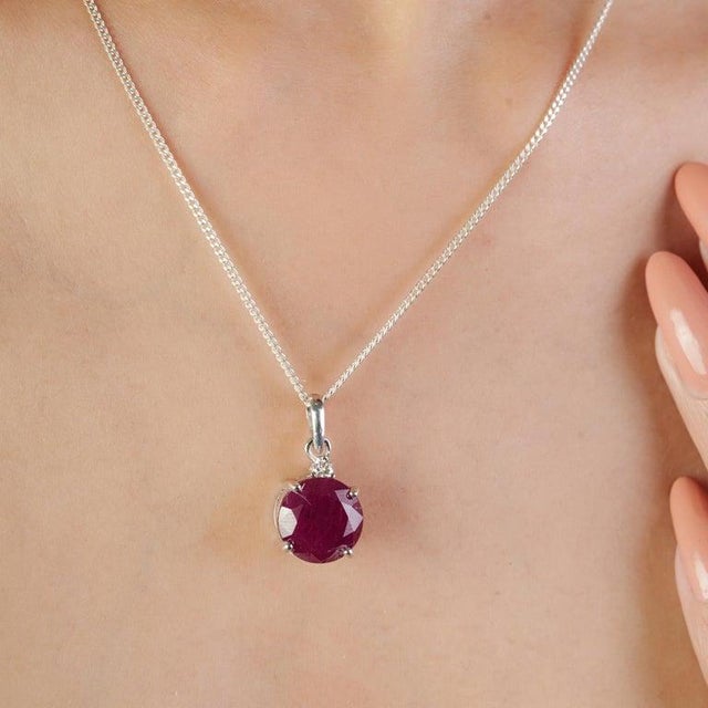 Add a touch of bold sophistication to your collection with this striking ruby pendant, expertly crafted in solid sterling...