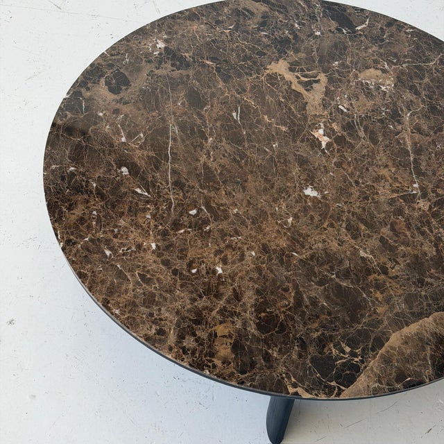 c. 2020. France. Brown Marble top with painted black base. This piece is attributed to the mentioned designer/maker. It...