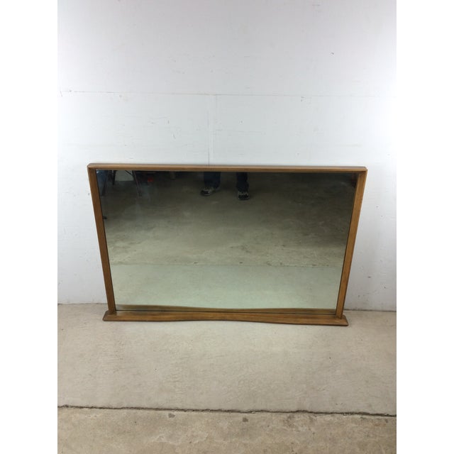 This mid century modern mirror by Heywood Wakefield features hardwood construction, original Sable finish, and vintage...