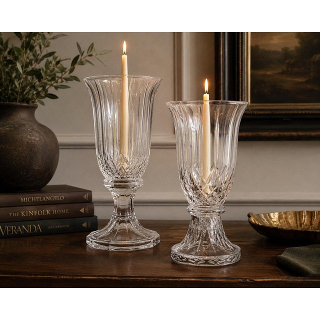 A beautifully collected near pair of vintage heavy cut glass hurricane candle holders showcasing timeless transitional...