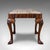 This is an antique Queen Anne revival dressing stool. An English, mahogany and needlepoint footstool, dating to the high...