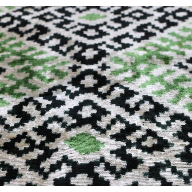 "Introduce a layer of organic sophistication to your curation with this masterfully hand-knotted silk ikat lumbar pillow....