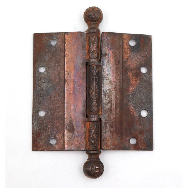 This antique Victorian door hinge is made of copper plated cast iron with ball tips, three knuckles, and a template hole...
