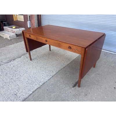 Hans J. Wegner Model 305 Writing Desk with two 18.75 drop-leaves on both ends. Iconic, beautiful and elegant design that...