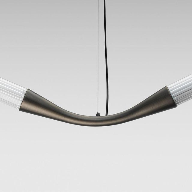A sculptural lighting system defined by a continuous S-shaped line, Ypsilon by Lorenza Bozzoli transforms the ceiling into...