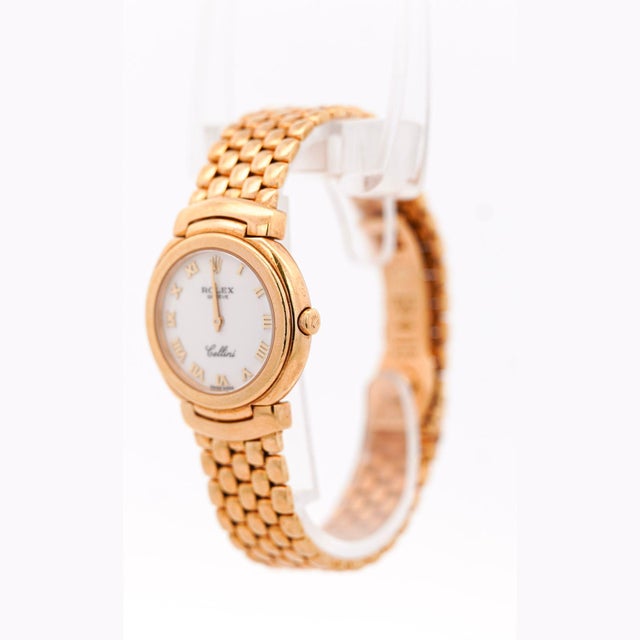 Vintage Rolex Cellini 6621 quartz watch in 18K yellow gold featuring 26mm case with white dial and integrated brick-link...