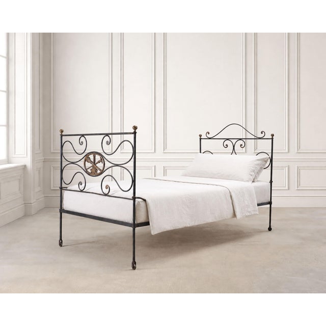 A charming 19th century French daybed or bed frame, crafted out of bronze and iron in a Napoleon III period style. The bed...