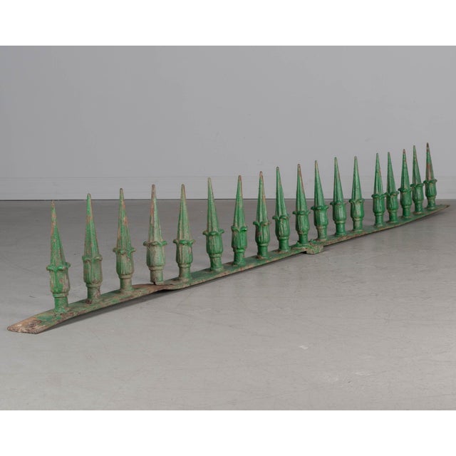 A 19th Century French decorative architectural wall spike rail with 18 cast iron spears. Original green painted patina...