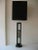 This vintage Danish ebonized tall wood and quartz stone mid century modern tall lamp has a center grouping of beautiful...