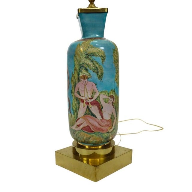 This vintage Neoclassical table lamp, dating from approximately 1940, features a hand-painted porcelain body mounted on a...