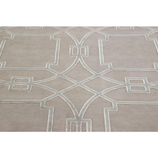 Meticulously crafted by hand using a blend of silk and wool, this exquisite contemporary rug from Tibet showcases a...