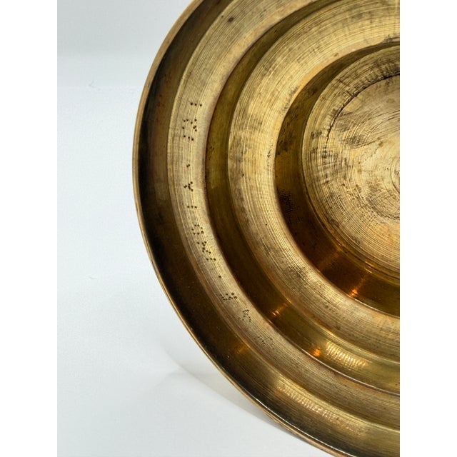 A beautifully detailed vintage brass decorative vase marked India on the bottom. This piece features engraved floral and...