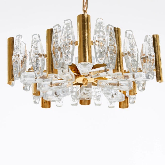 Gold-plated, pressed glass brass chandelier, fitted with five E14 sockets, designed in the 1960s in Sweden by Carl...