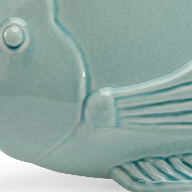 Celadon Fish is a whimsical fish perfect for your waterfront home. This nature inspired item is crafted of celadon crackle...