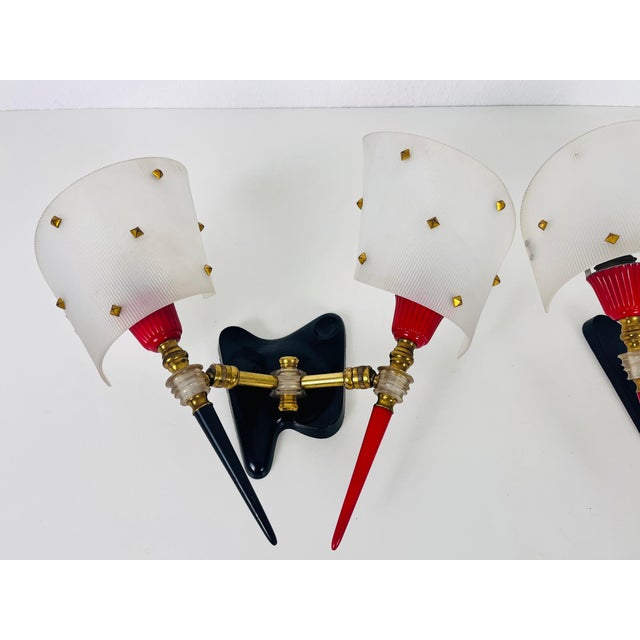 Maison Arlus sconces made in France in the 1960s. The body is made of plastic with beautiful brass ornaments. The shades...