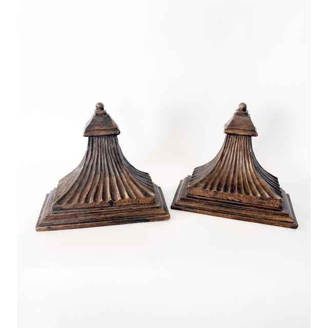 Elegant rustic pair of antique hand-carved wood wall brackets. These brackets feature a timeless fluted, tapering body and...