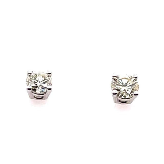 14 Karat White Gold And Round Diamond Four Prong Stud Earrings Screw back 0.40 total diamond weight 0.91 grams total weight.