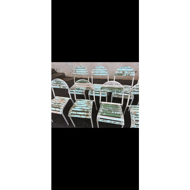 Set of 10 chairs with metal frames and wooden slats, in their original configuration, with wear consistent with age and...