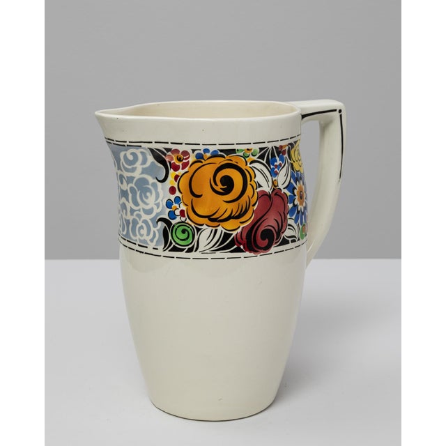 This 20th Century Belgian ceramic pitcher stands out with its bold, vibrant floral band, showcasing the lively decorative...