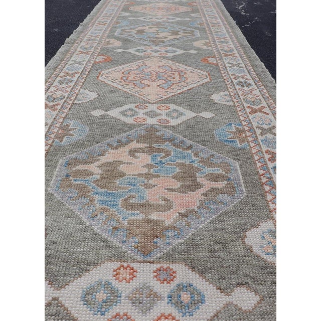 Measures: 3'1 x 11'8 Turkish Oushak Runner in Soft Coral, Slate Gray, and Ivory with Geometric Medallions. Keivan Woven...
