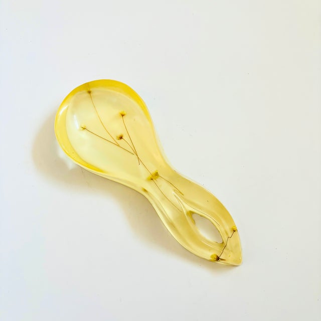 A wonderful vintage acrylic spoon rest. Pale yellow color to the acrylic with lovely dried flowers encased in the resin.