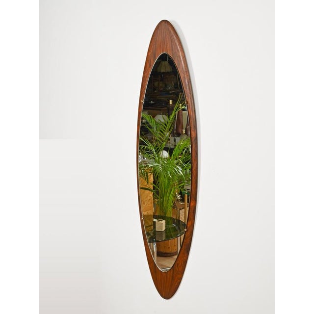 Spectacular and sculptural large wall mirror in Italian wall mirror in a gorgeous rosewood with brass accents. This...