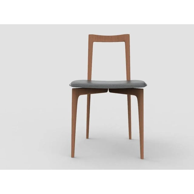 with its light and solid wood structure, this chair is suitable for contemporary interiors. Its proportions and reduced...