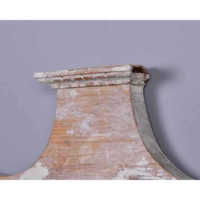 Found in England, this circa 1900 carved pine pediment has a limed wood finish. This is a large piece at just under two...