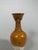 A covered terracotta vase with an amber glaze, Tang Dynasty (618-907). The upper part, covered with an amber glaze, has a...
