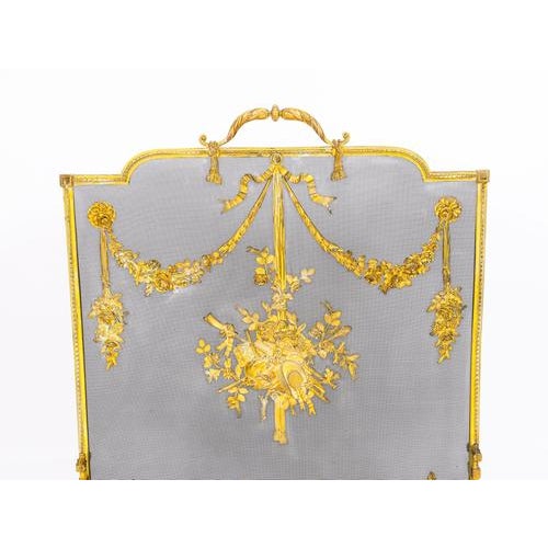This is a superb and very decorative French Rococo revival ormolu and mesh fire-screen, circa 1870 in date. The shaped...